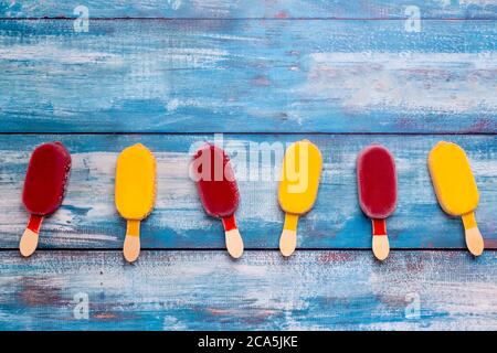 Fruit ice cream stick looks fresh to eat placed on a blue vintage wooden. Stock Photo