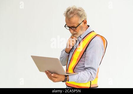 Senior foreman or engineer using laptop computer. Stock Photo