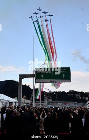 Genoa, Italy. 03rd Aug, 2020. People take pictures of the Italian Air Force aerobatic unit Frecce Tricolori (Tricolor Arrows) spreading smoke with the colors of the Italian flag during the official inauguration ceremony of the new San Giorgio bridge.The new San Giorgio bridge designed by architect Renzo Piano replaces Morandi bridge that collapsed in August 2018 and the new bridge is set to reopen on 05 August 2020 during the inauguration ceremony. Credit: SOPA Images Limited/Alamy Live News Stock Photo