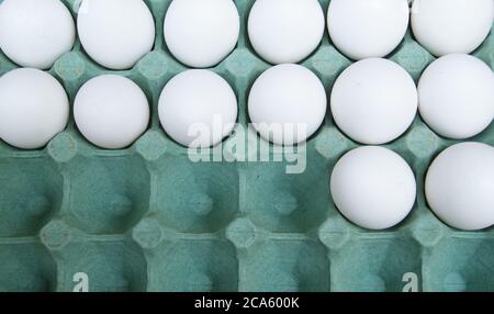 Egg carton with white eggs, also used as wallpaper or decorative background, with missing eggs, Brazil, South America Stock Photo