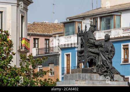 Monument of Elizabeth the Catholic and Christopher Columbus in Granada with a blue building in the background Stock Photo