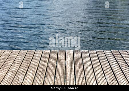wooden planks of a jetty at lake for background use Stock Photo