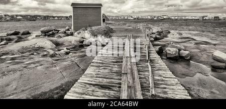 View of fishing stage on sea coastline, Tilting, Fogo Island, Newfoundland Stock Photo