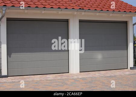 Two modern new garage doors (sectional doors) Stock Photo