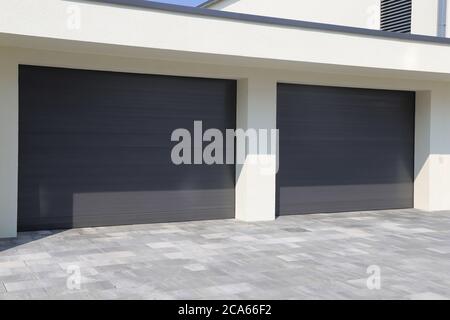 Two modern new garage doors (sectional doors) Stock Photo