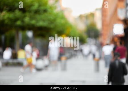 blurred background. people walking on sunny city street in summer Stock Photo