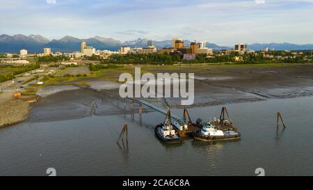 Tug boats are moored at a private dock near Fish Creek in the Coook Inlet Alaska Stock Photo