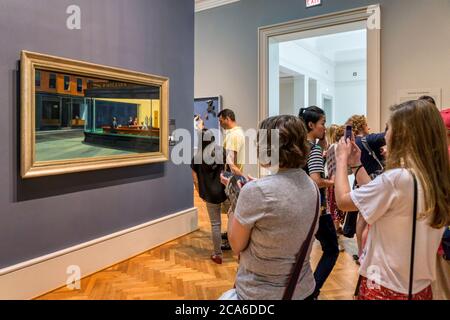 People looking at Nighthawks by Edward Hopper in a gallery at the Art Institute of Chicago. Stock Photo