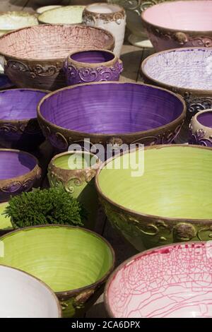 Rustic ceramic bowls in vibrant colors for sale Stock Photo