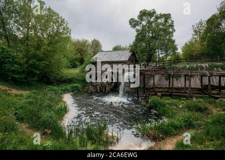 Old wooden log watermill in Russian village Stock Photo