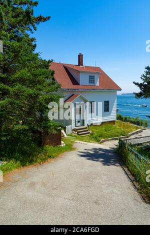 A walkway leads to the lightkeeper house for Bass Harbor Lighthouse iin Maine.  The house is no longer occupied. Stock Photo