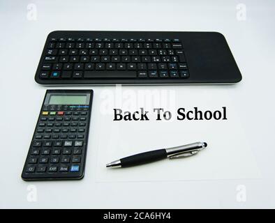 Computer keyboard, calculator, pen, isolated on white background. Back to school concept Stock Photo