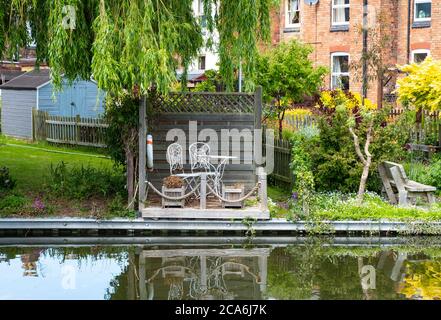 Place in a garden to relax by a canal Stock Photo