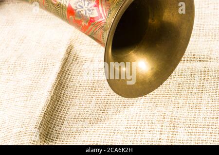 rustic coarse canvas fabric and a copper jug with ornament, close-up, background Stock Photo