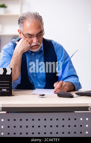 Old male author writing the screenplay Stock Photo