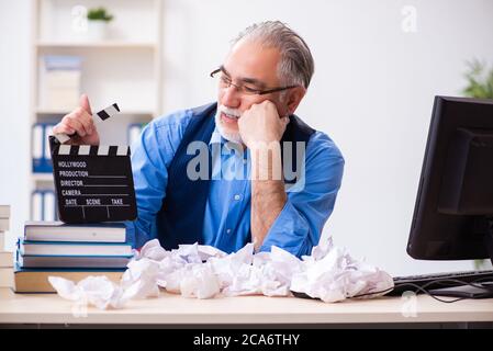 Old male author writing the screenplay Stock Photo