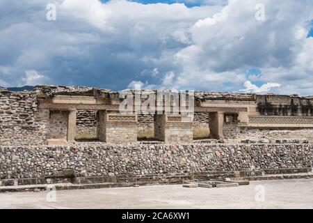 The ruins of Building 10 in Courtyard F in the Zapotec city of Mitla in Oaxaca, Mexico.  In front on the plaza is the entrance to Tomb 2.  A UNESCO Wo Stock Photo