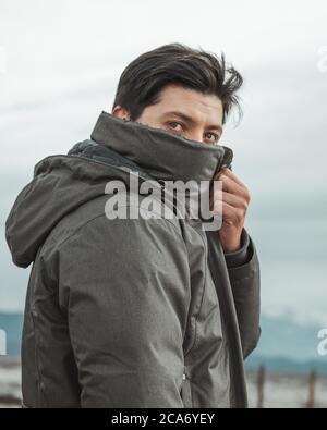 young man with his face covered where I can see his deep eyes Stock Photo