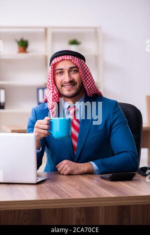 Young male arab employee working in the office Stock Photo