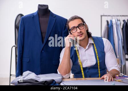 Young tailor working at workshop Stock Photo