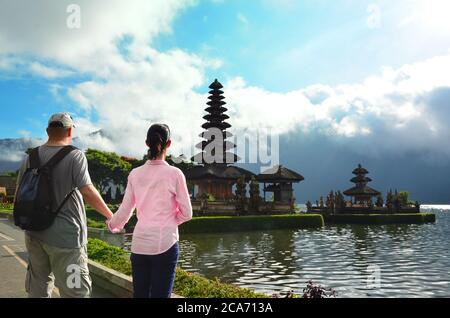 Couple near the famous temple Pura Ulun Danu at Beratan lake, Bali Stock Photo