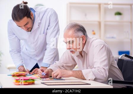 Doctor and patient suffering from the Alzheimer disease Stock Photo