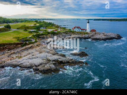 Aerial view of Portland Head Lighthouse in Maine as the sun begins to set over the east coast of the United States Stock Photo