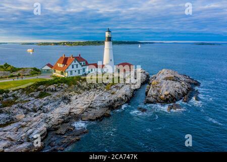 Aerial view of Portland Head Lighthouse in Maine as the sun begins to set over the east coast of the United States Stock Photo