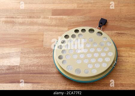 Classic green mosquito coil in a metal plate on table Stock Photo