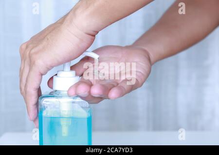 Close-up Hand man using hand sanitizer gel . Coronavirus hand sanitizerr gel for clean hands hygiene corona virus . Man using alcohol gel clean hand. Stock Photo
