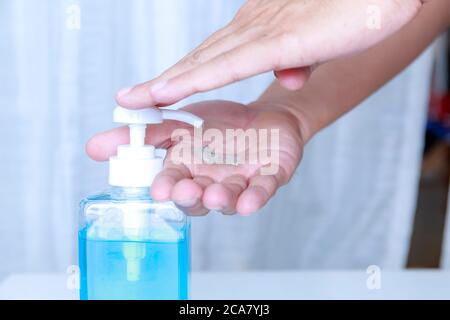 Close-up Hand man using hand sanitizer gel . Coronavirus hand sanitizerr gel for clean hands hygiene corona virus . Man using alcohol gel clean hand. Stock Photo