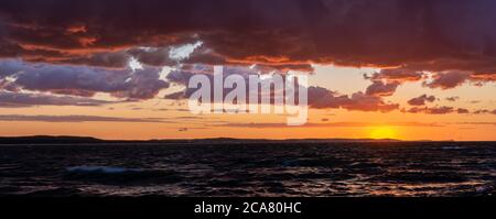 dramatic sunset over the stormy sea Stock Photo