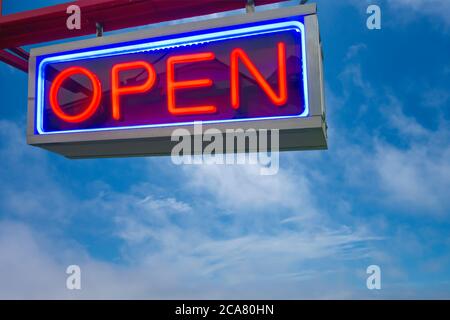 open neon sign red and lue on sky background Stock Photo