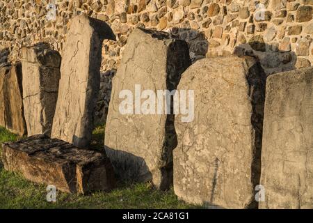 The Danzantes are figures carved in stone showing what are thought to be mutilated captives at the pre-Columbian Zapotec ruins of Monte Alban in Oaxac Stock Photo