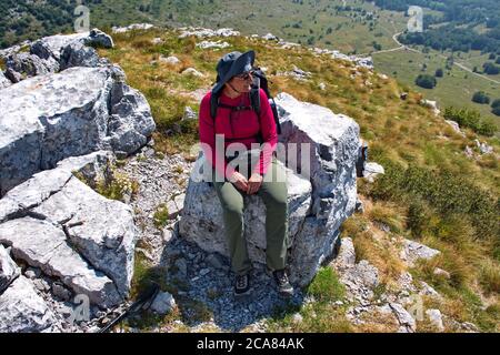 Senior woman hiking in Velebit mountain, Croatia Stock Photo