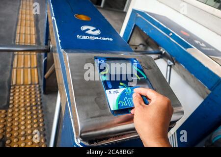 Jakarta / Indonesia - August 3, 2020. the tap-in and tap-out process at the Transjakarta bus stop gate uses a jaklinko card Stock Photo