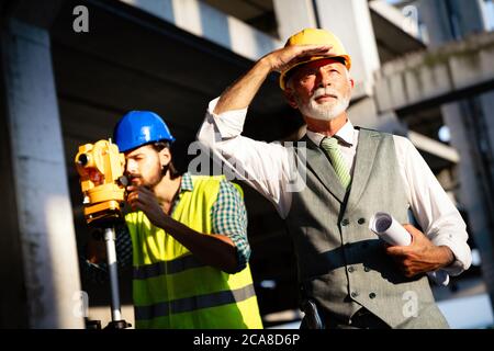 Engineer, contractor, architect teamwork. Construction people talking and planning work, blueprint Stock Photo