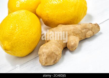 lemons and ginger root on white wooden background Stock Photo