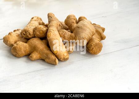 a bunch of ginger on a white wooden background. healthy food Stock Photo