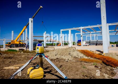 Total center device with laser for leveling other devices to level construction site. Stock Photo