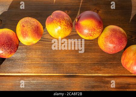 ripe juicy nectarines on a wooden background. space for text, close-up Stock Photo