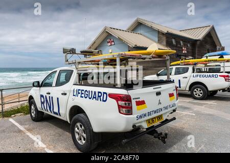 Two RNLI Emergency response vehicles parked in a car park overlooking Fistral Beach in Newquay in Cornwall. Stock Photo