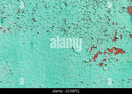 old rusty green iron surface. old paint is peeling off the surface Stock Photo