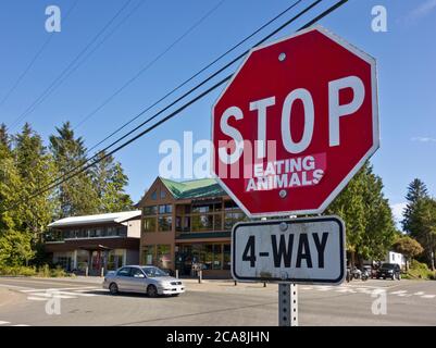 Stop Sign Eating System Road sign, Stop sign with sticker „eating animals“, sky with dark ...