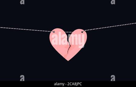 Pink heart shaped paper with torn marks hanging on the rope. Broken heart,unrequited love. Stock Photo