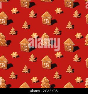 Gingerbread cookies of different Christmas shapes on red. Pattern Stock Photo