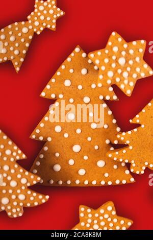 Gingerbread Christmas tree with other cookies balance on red Stock Photo