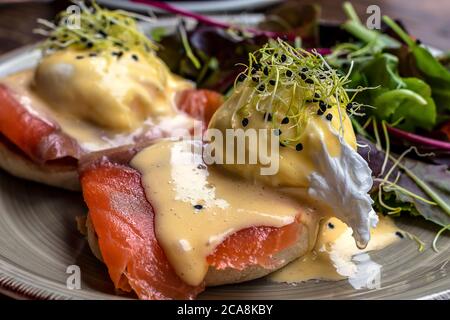Egg Benedict with smoked salmon and fresh Hollandaise sauce. Stock Photo