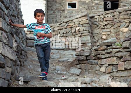 Xinaliq / Azerbaijan - July 8, 2019: portrait of boy on streets of stone houses village Stock Photo