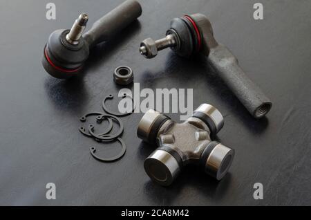 Cross joint of the propeller shaft and a set of tie rod ends. New auto parts for transmission. Trade Auto parts, car service. Automotive industry. Sel Stock Photo